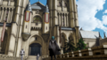 Byleth in front of the Garreg Mach cathedral.