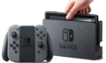 A Nintendo Switch docked and the Joy-Con attached to the controller attachment.